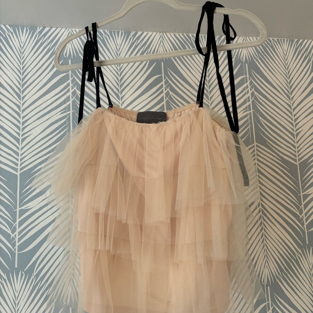 cream tiered tank with adjustable black ties .